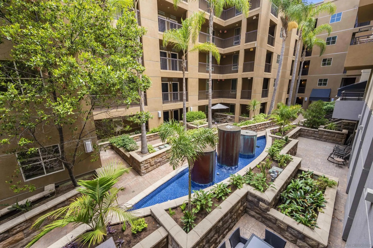 Landscaped courtyard with palms, fountains and lounge seating